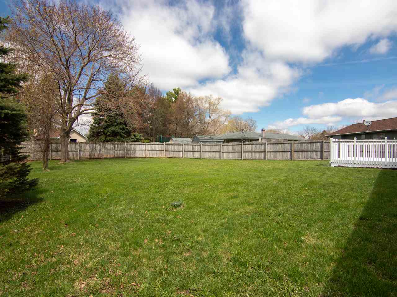 3943 Cutty Sark Road Cherry Valley, IL 61016 - Photo 24 of 25 a view of a house with a big yard and a large tree