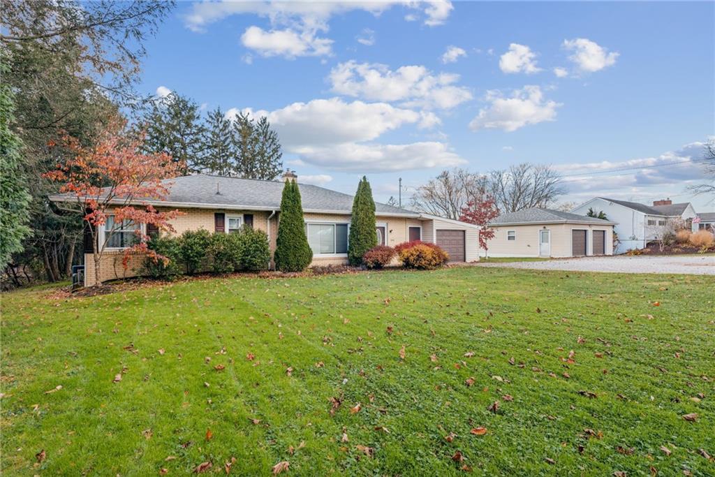 a front view of a house with garden