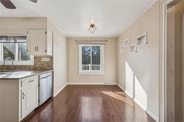 a kitchen with a wooden floor and window