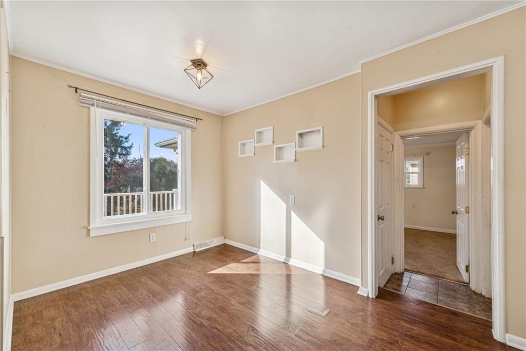 104 Ekastown Road Sarver, PA 16055 - Photo 19 of 39 a view of an empty room with wooden floor and a window
