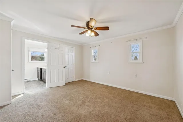 a view of a livingroom with a ceiling fan and window