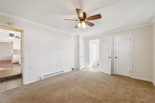 a view of a livingroom with a ceiling fan & entryway