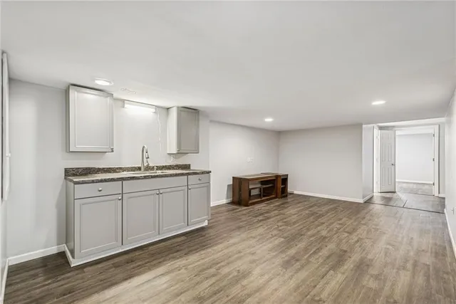 a kitchen with granite countertop a sink and cabinets