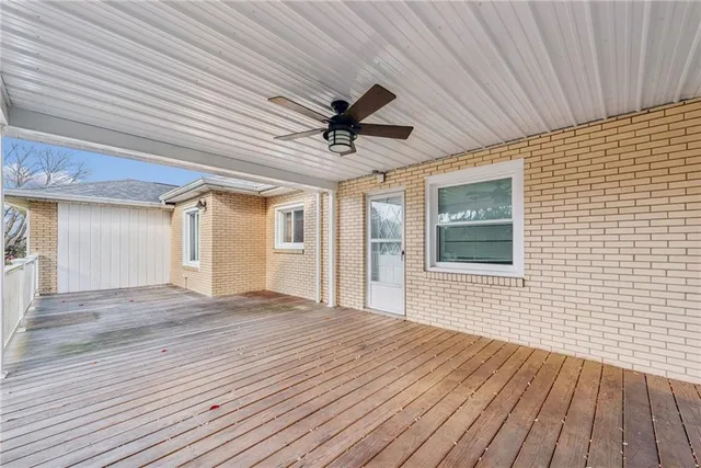 a view of a livingroom with wooden floor and a ceiling fan