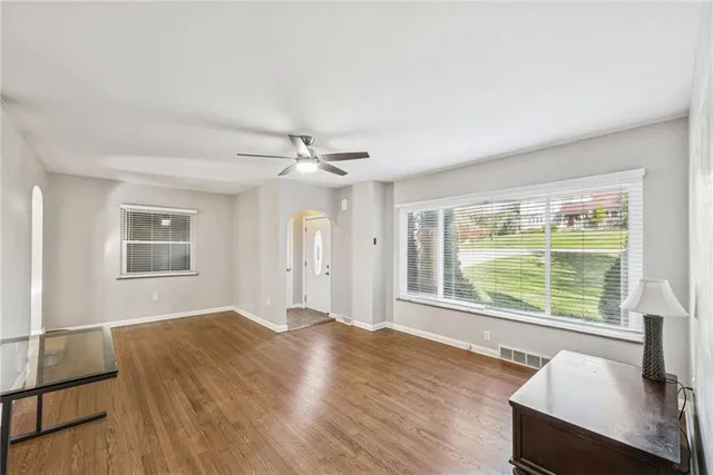 a view of a livingroom with a window and wooden floor