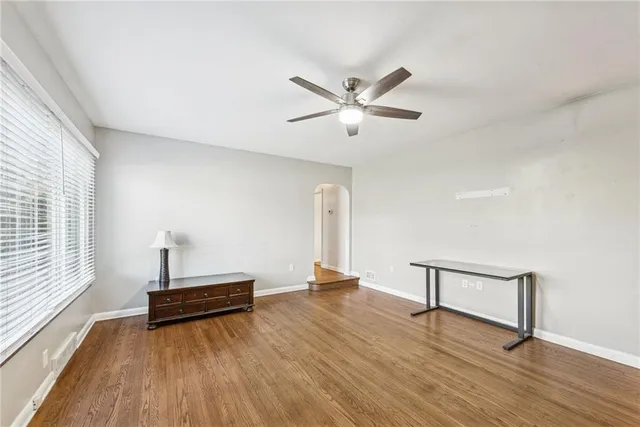 a view of room with hardwood floor and ceiling fan