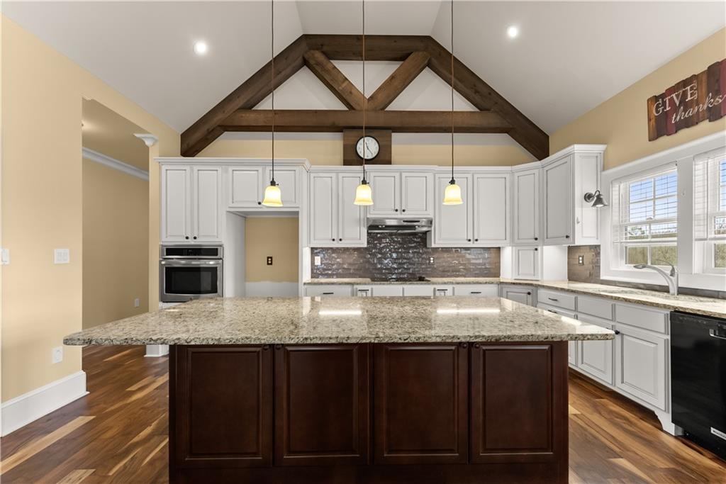 725 County Farm Road Jefferson, GA 30549 - Photo 18 of 66 a kitchen with stainless steel appliances granite countertop a sink a stove and a wooden cabinets