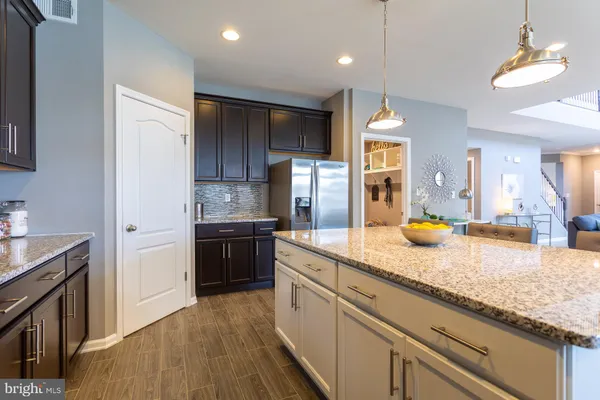 a kitchen with a sink dishwasher a stove and a refrigerator with wooden floor