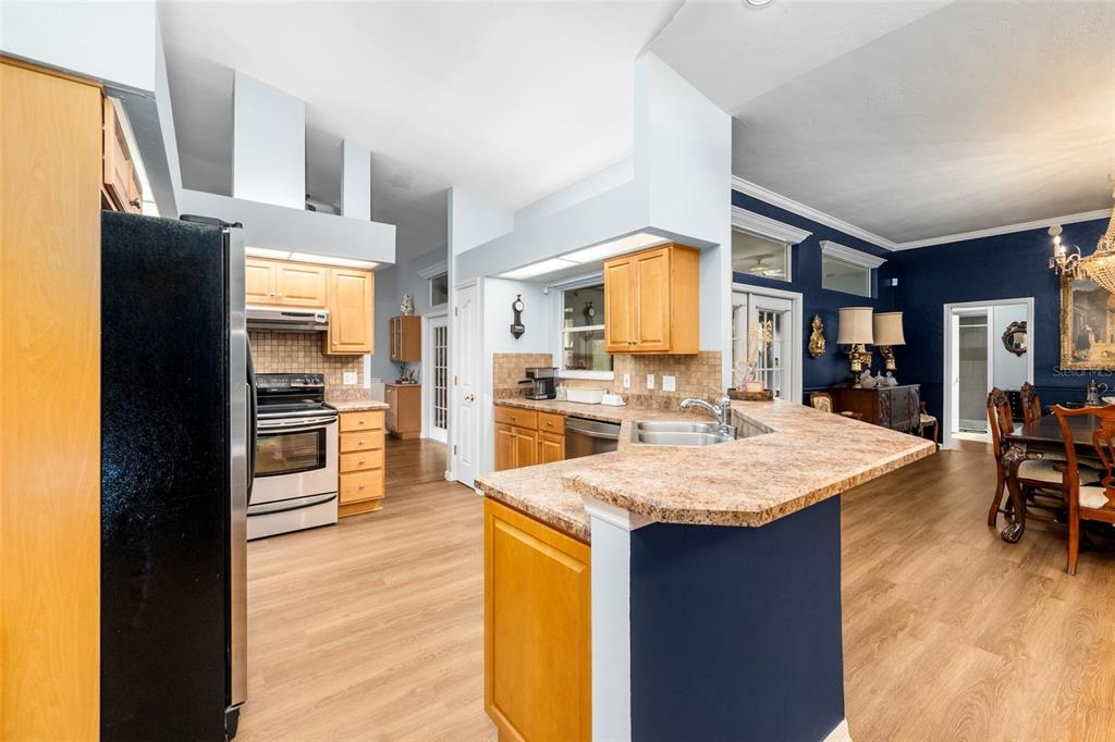 3448 Northwest 68 Road Gainesville, FL 32653 - Photo 15 of 51 a large kitchen with a table and chairs