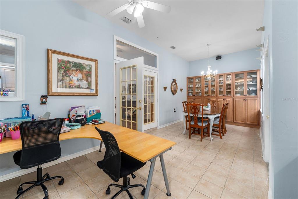 3448 Northwest 68 Road Gainesville, FL 32653 - Photo 21 of 51 a view of a dining room with furniture and a chandelier