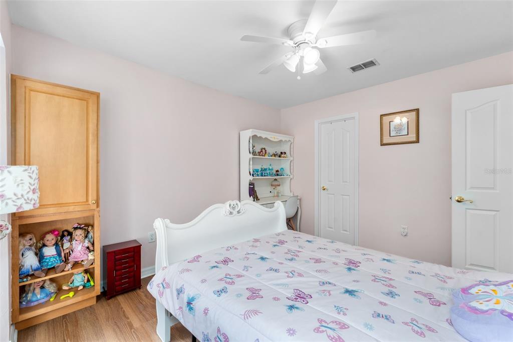 3448 Northwest 68 Road Gainesville, FL 32653 - Photo 28 of 51 a bedroom with a bed and a chandelier