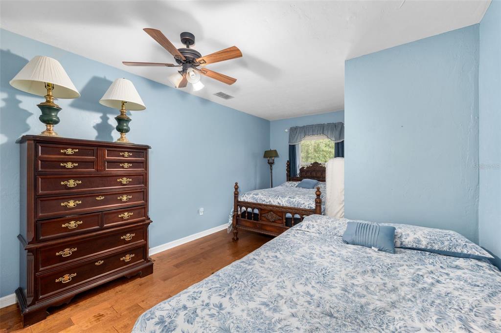 3448 Northwest 68 Road Gainesville, FL 32653 - Photo 34 of 51 a bedroom with a bed and wooden floor