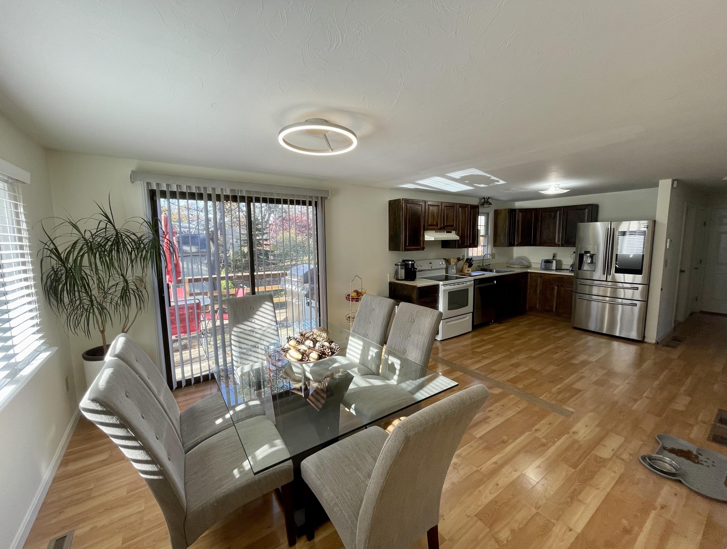 97 Braley Jenkins Road Centerville, MA 02632 - Photo 13 of 39 a view of a dining room with furniture wooden floor and chandelier