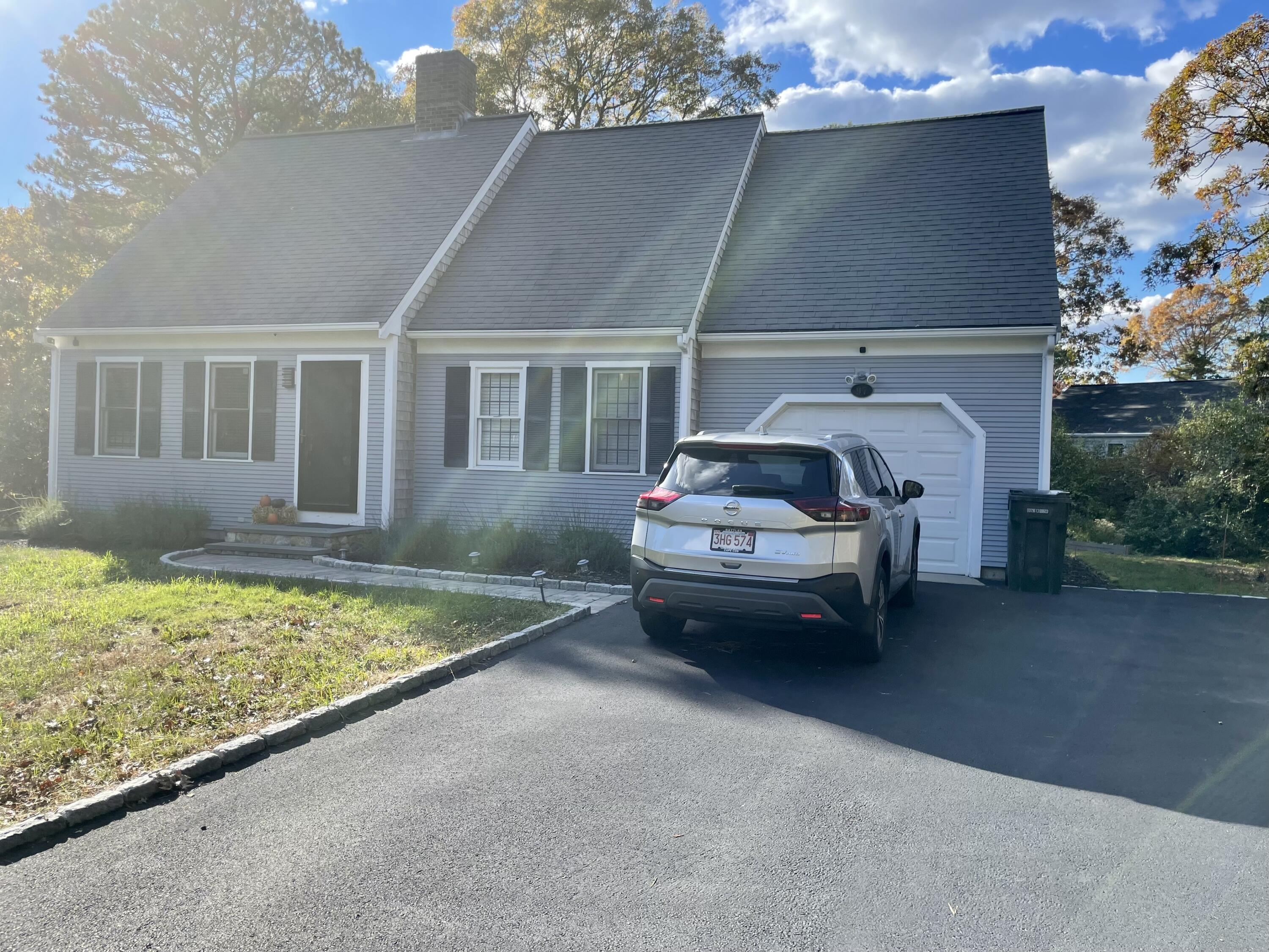 97 Braley Jenkins Road Centerville, MA 02632 - Photo 2 of 39 a car parked in front of a house