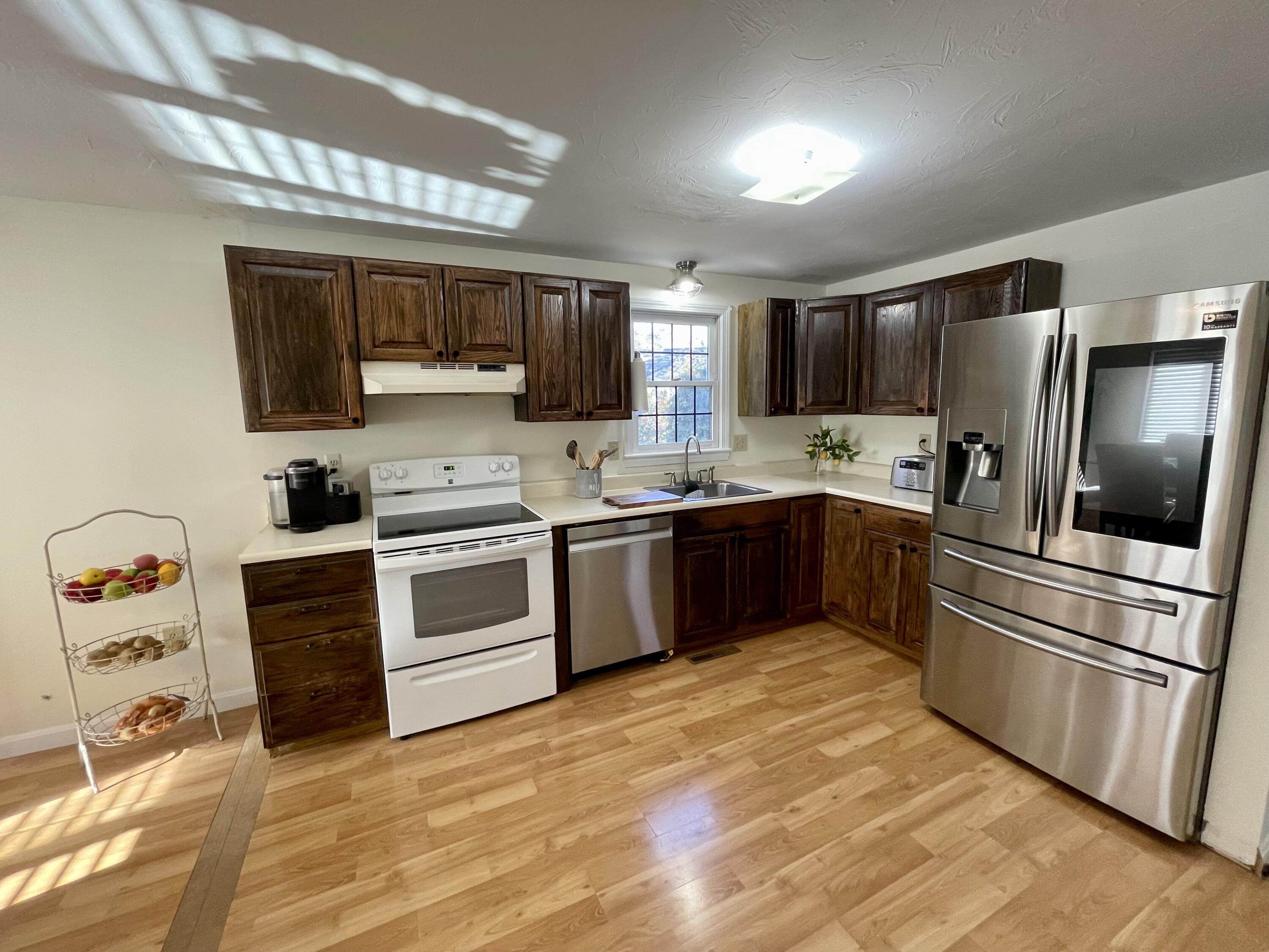 97 Braley Jenkins Road Centerville, MA 02632 - Photo 21 of 39 a kitchen with stainless steel appliances granite countertop a stove a sink and a refrigerator
