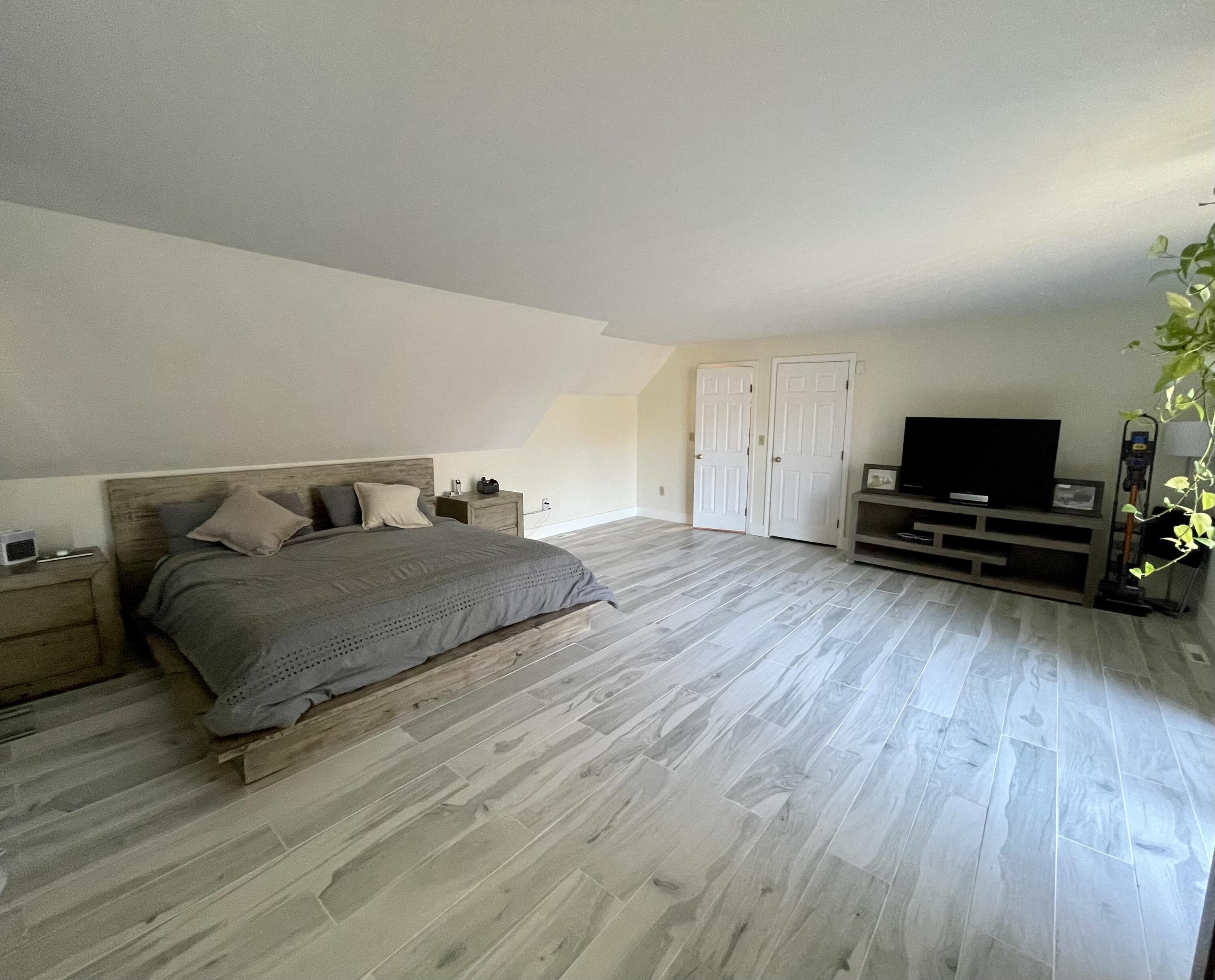 97 Braley Jenkins Road Centerville, MA 02632 - Photo 22 of 39 a bedroom with a bed and a tv on table