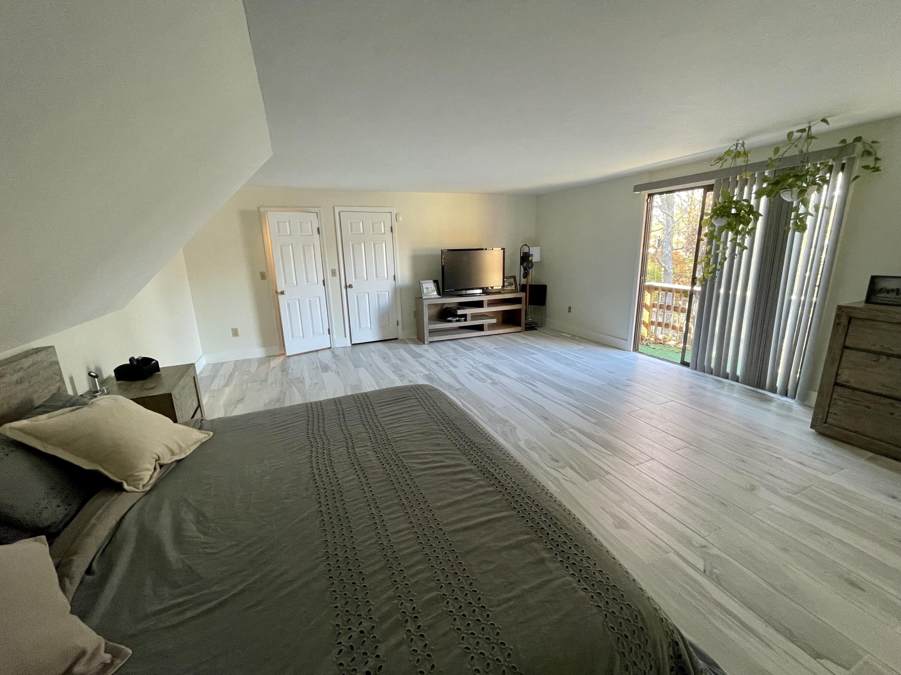 97 Braley Jenkins Road Centerville, MA 02632 - Photo 24 of 39 a bed sitting in a spacious bedroom next to a window