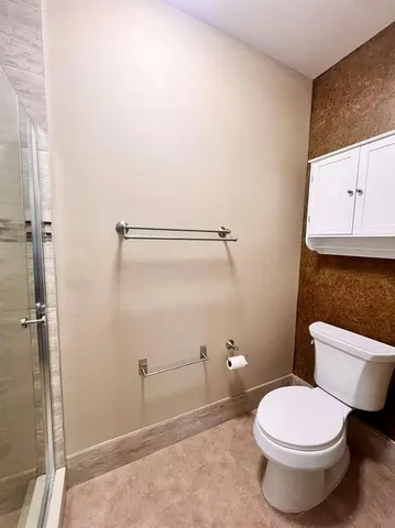 a bathroom with a glass shower door