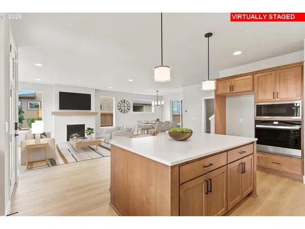 a kitchen with a sink a counter top space appliances and cabinets