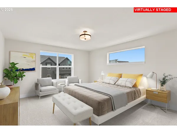 a bedroom with a bed and a large window
