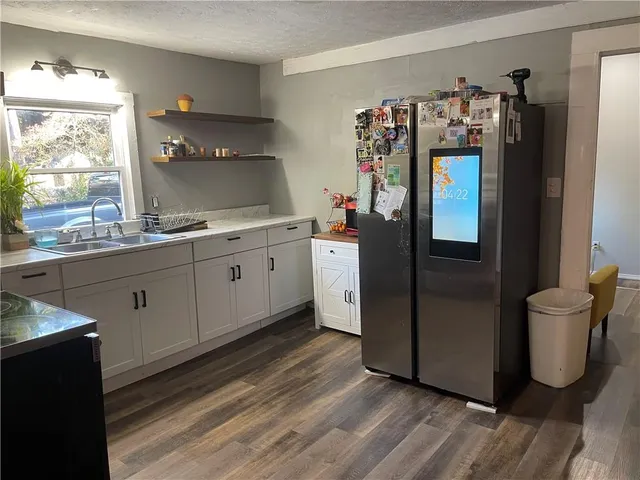 a kitchen with refrigerator and window