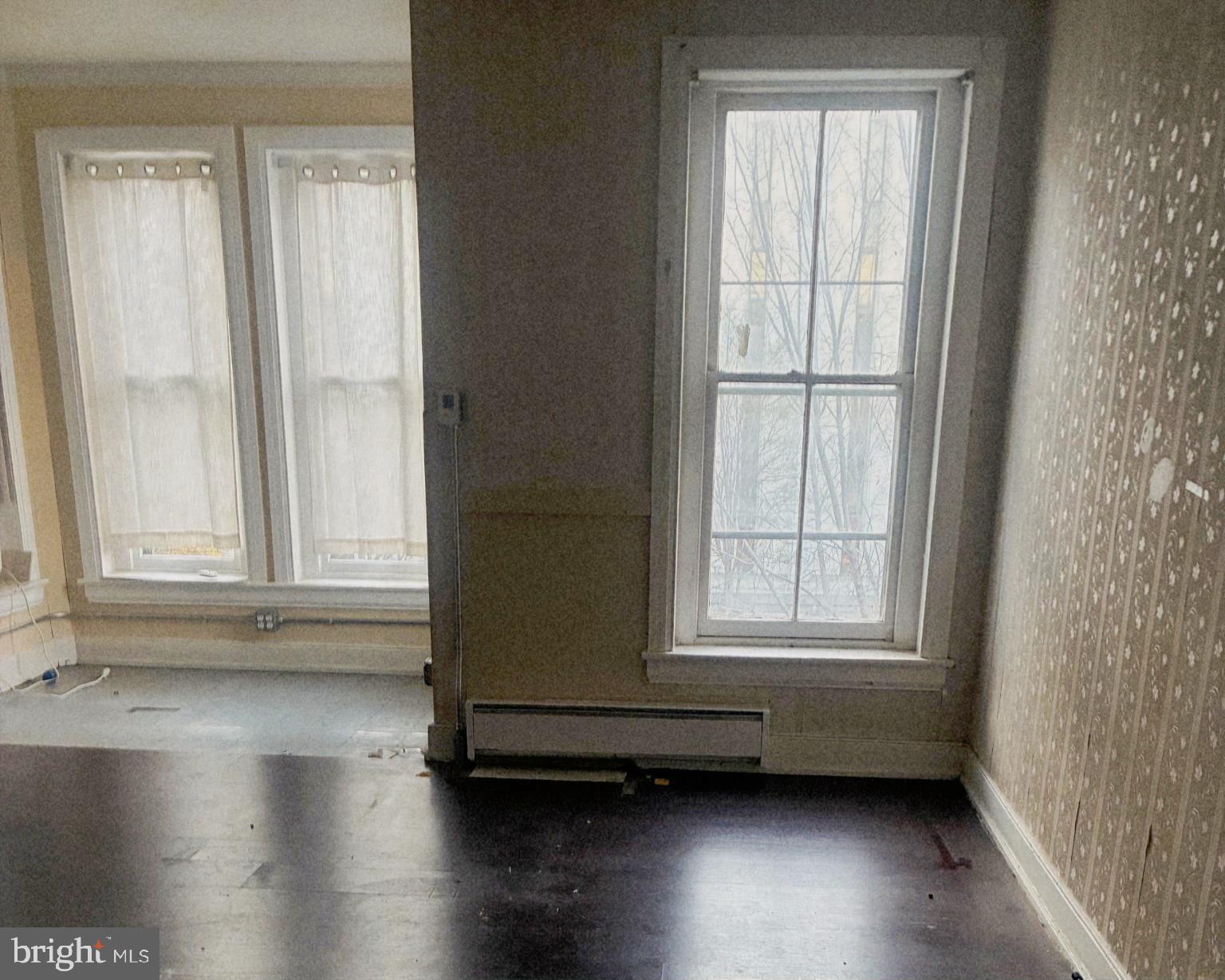 214 2nd Street Southeast Washington, DC 20003 - Photo 9 of 12 an empty room with wooden floor and windows
