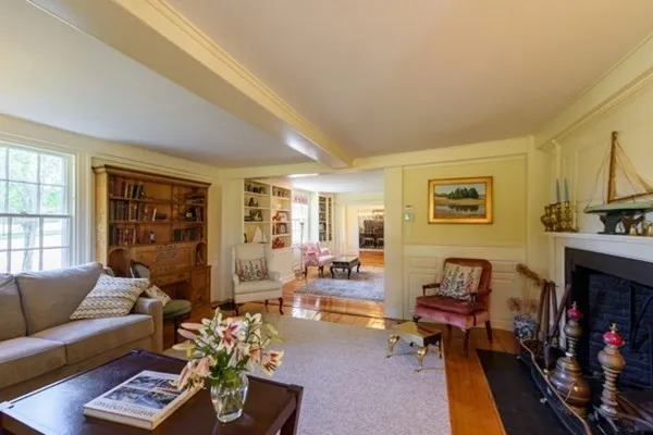 a living room with furniture fireplace and a window