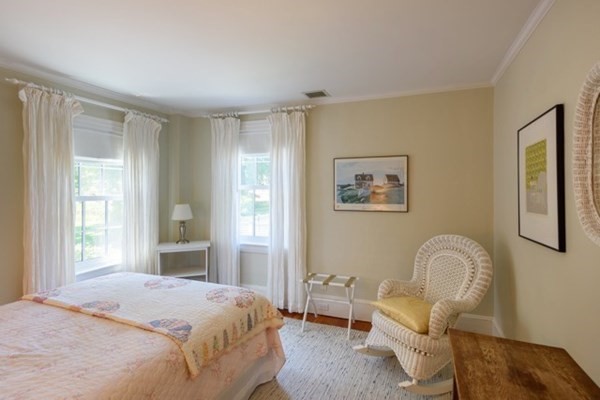 31 Lamberts Cove Road Tisbury, MA 02568 - Photo 22 of 35 a bedroom with a bed chair and a window