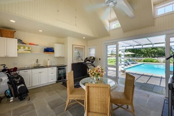 a view of a house with backyard porch and sitting area