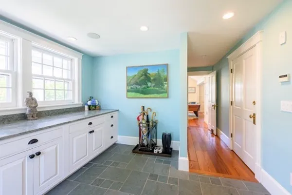 a hallway with mirror and window