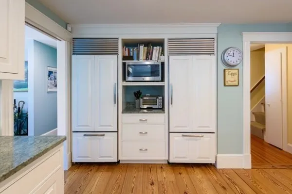 a kitchen with a refrigerator and a stove