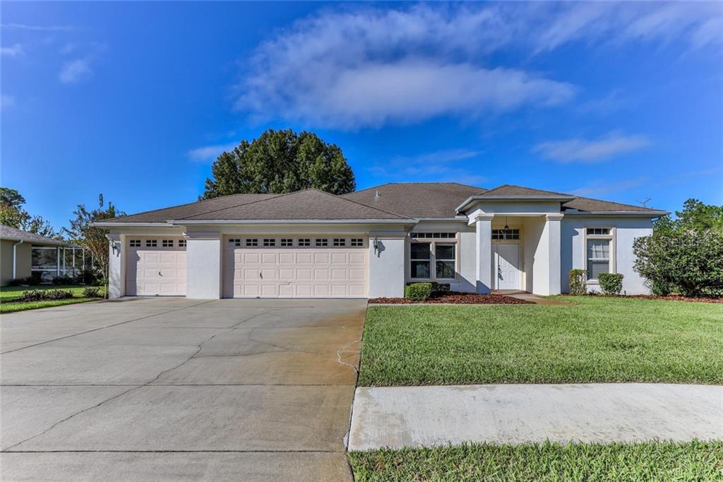 4531 Secretariat Run Spring Hill, FL 34609 - Photo 1 of 1 a front view of a house with a yard and garage