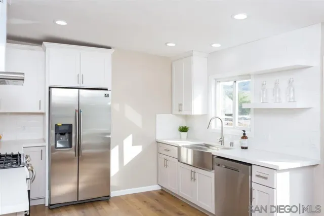 a kitchen with cabinets and stainless steel appliances