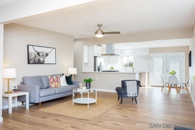 a living room with furniture and kitchen view