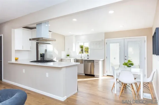 a kitchen with counter top space and wooden floor