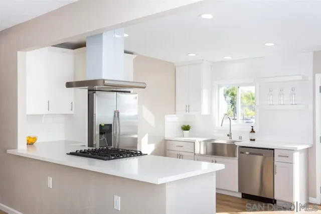 a kitchen with a sink and a stove top oven