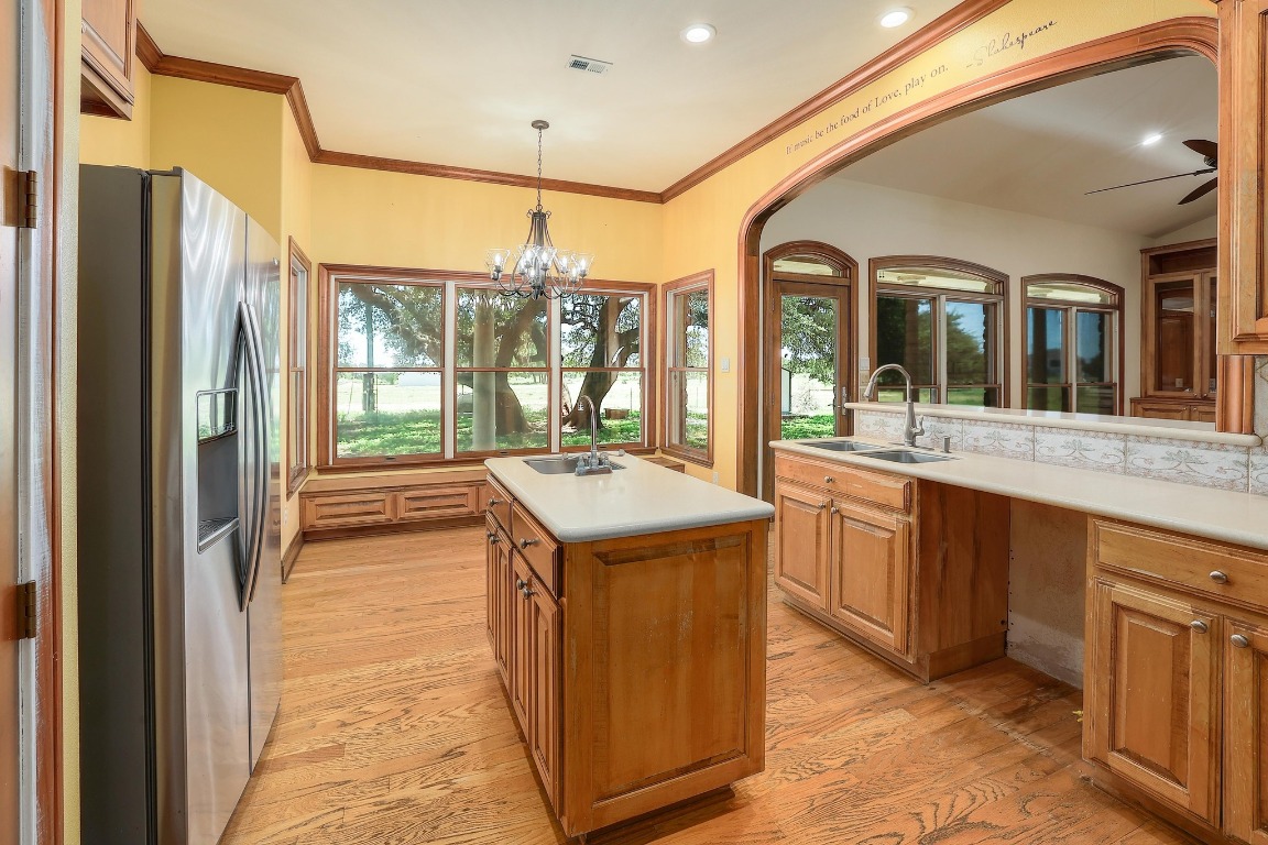 3900 Shell Road Georgetown, TX 78628 - Photo 12 of 40 a kitchen with a stove a refrigerator and a sink