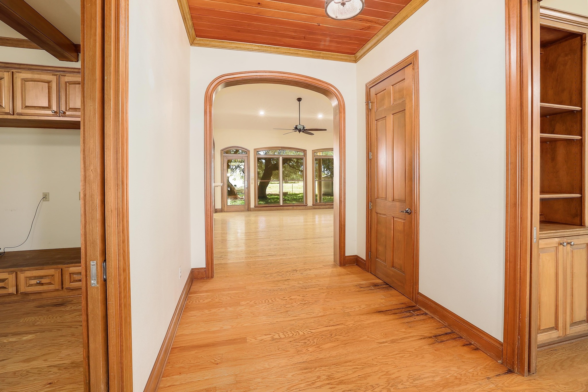 3900 Shell Road Georgetown, TX 78628 - Photo 13 of 40 Corridor featuring arched walkways, light wood finished floors, ornamental molding, and wood ceiling
