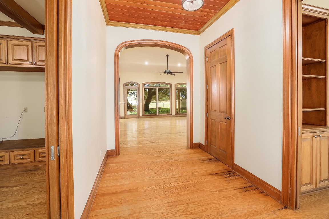 3900 Shell Road Georgetown, TX 78628 - Photo 13 of 40 a view of a hallway with wooden floor and a bathroom