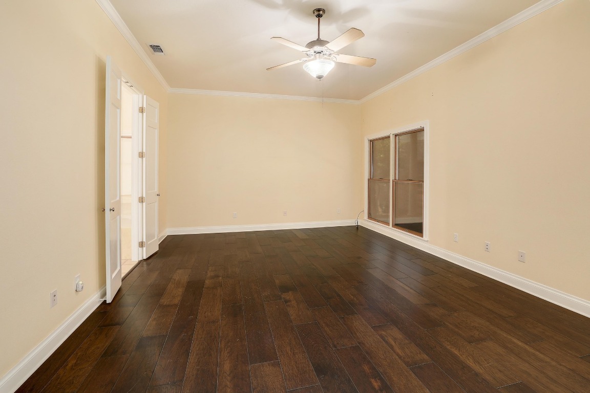 3900 Shell Road Georgetown, TX 78628 - Photo 17 of 40 an empty room with wooden floor and ceiling fan