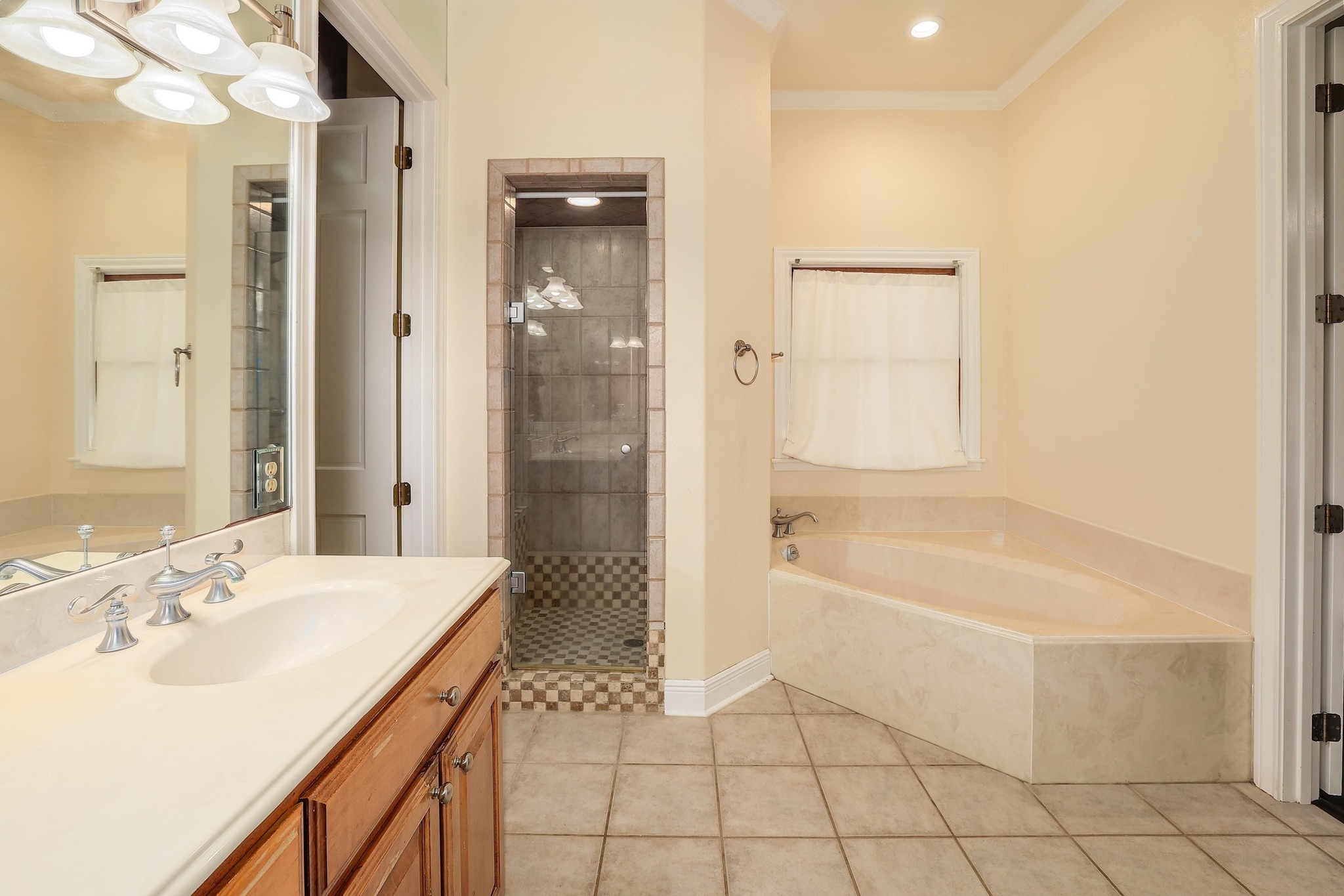 3900 Shell Road Georgetown, TX 78628 - Photo 20 of 40 Full bathroom with vanity, a stall shower, a bath, light tile patterned flooring, and crown molding