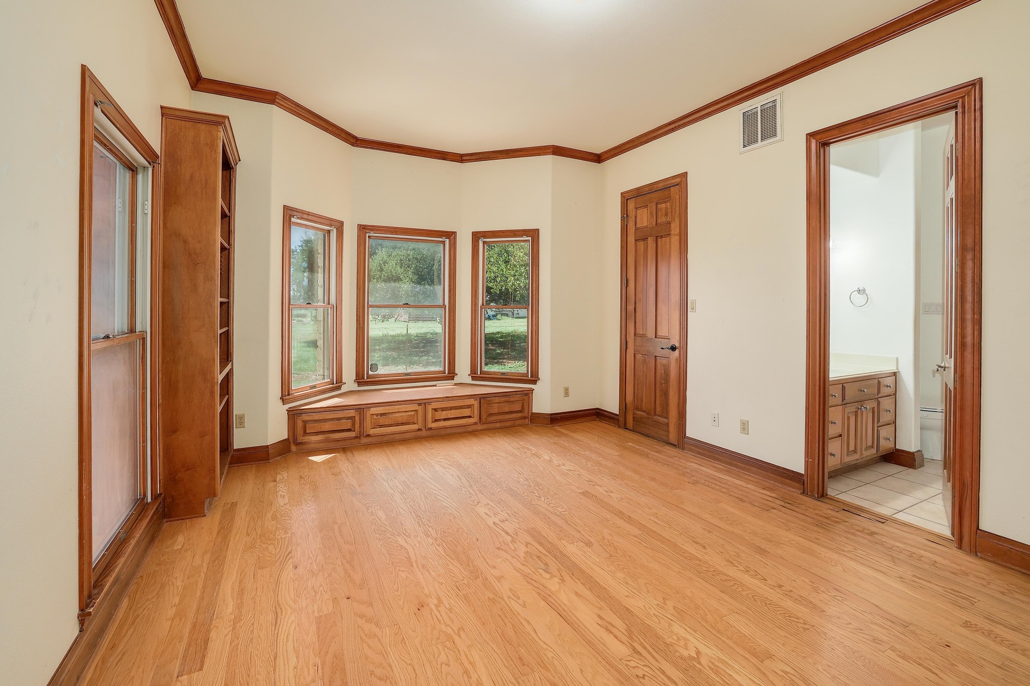 3900 Shell Road Georgetown, TX 78628 - Photo 25 of 40 Unfurnished bedroom featuring ornamental molding, light wood finished floors, and ensuite bath
