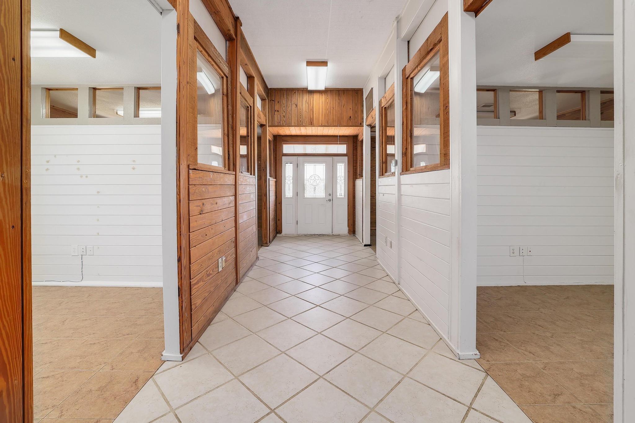 3900 Shell Road Georgetown, TX 78628 - Photo 32 of 40 Hallway featuring wood walls and light tile patterned flooring