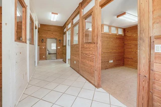 a view of a hallway with cabinets