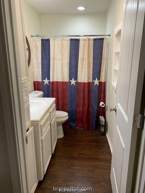 3005 1st Street Bryan, TX 77801 - Photo 13 of 18 a bathroom with a sink a mirror and a shower