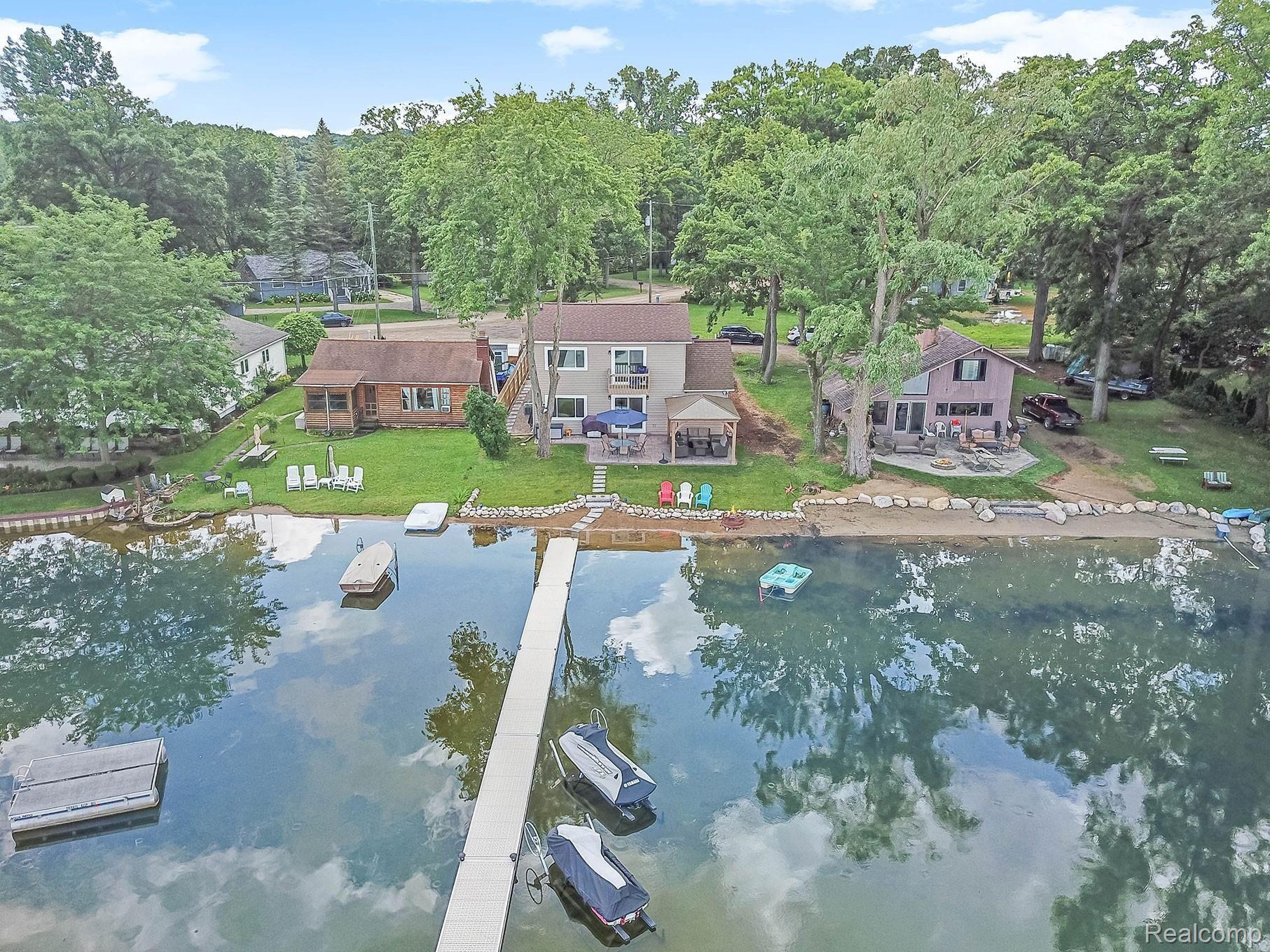 8776 Riverside Drive Brighton, MI 48116 - Photo 1 of 38 Beautiful Lake front home on Ore Lake with unique access to the Huron River and Portage chain of lakes