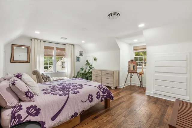 a bedroom with a bed and a dresser in it