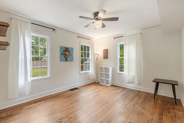 a bathroom with a granite countertop sink a toilet and a mirror