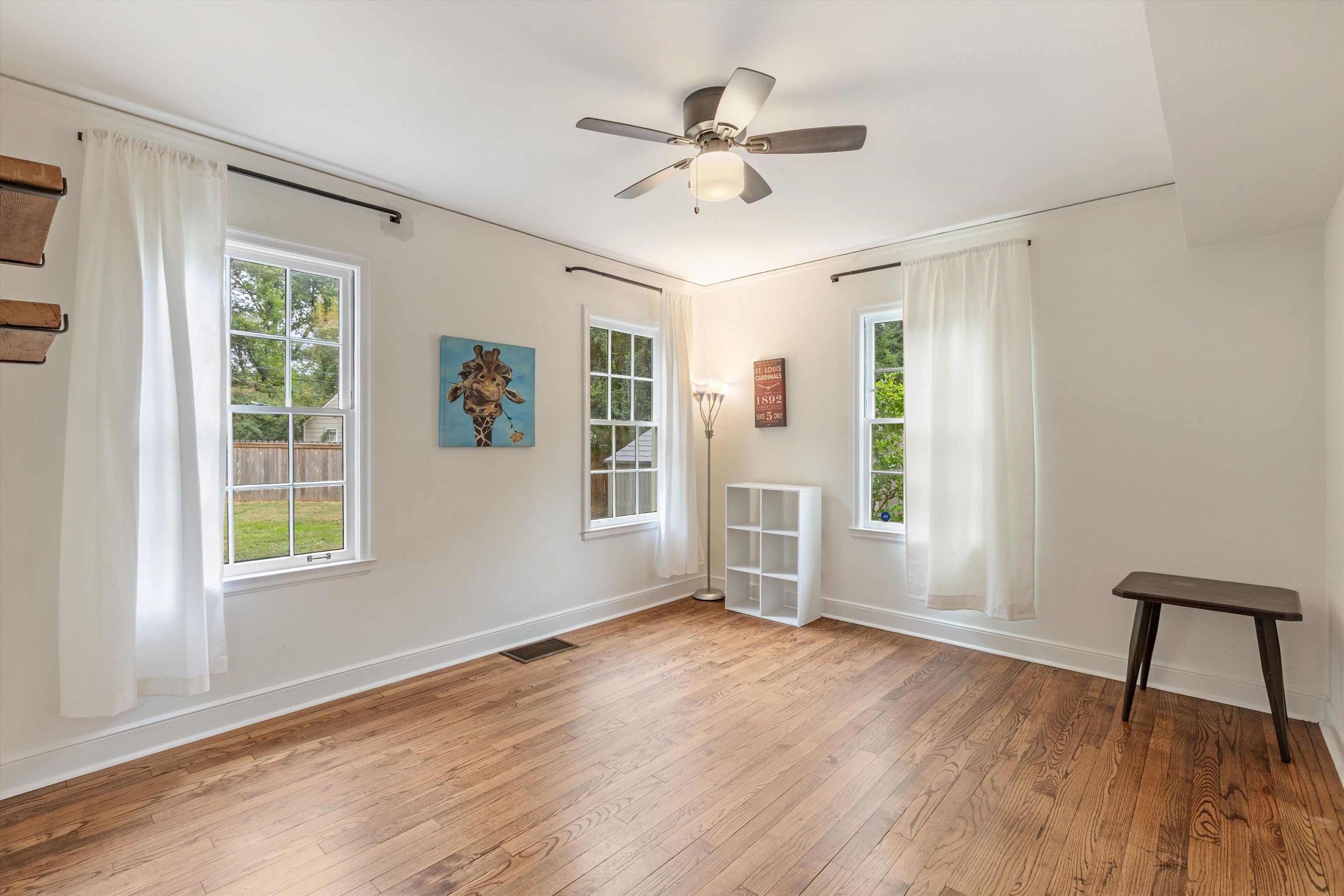 165 Picardy Street Memphis, TN 38111 - Photo 17 of 28 a view of an empty room with a window and wooden floor