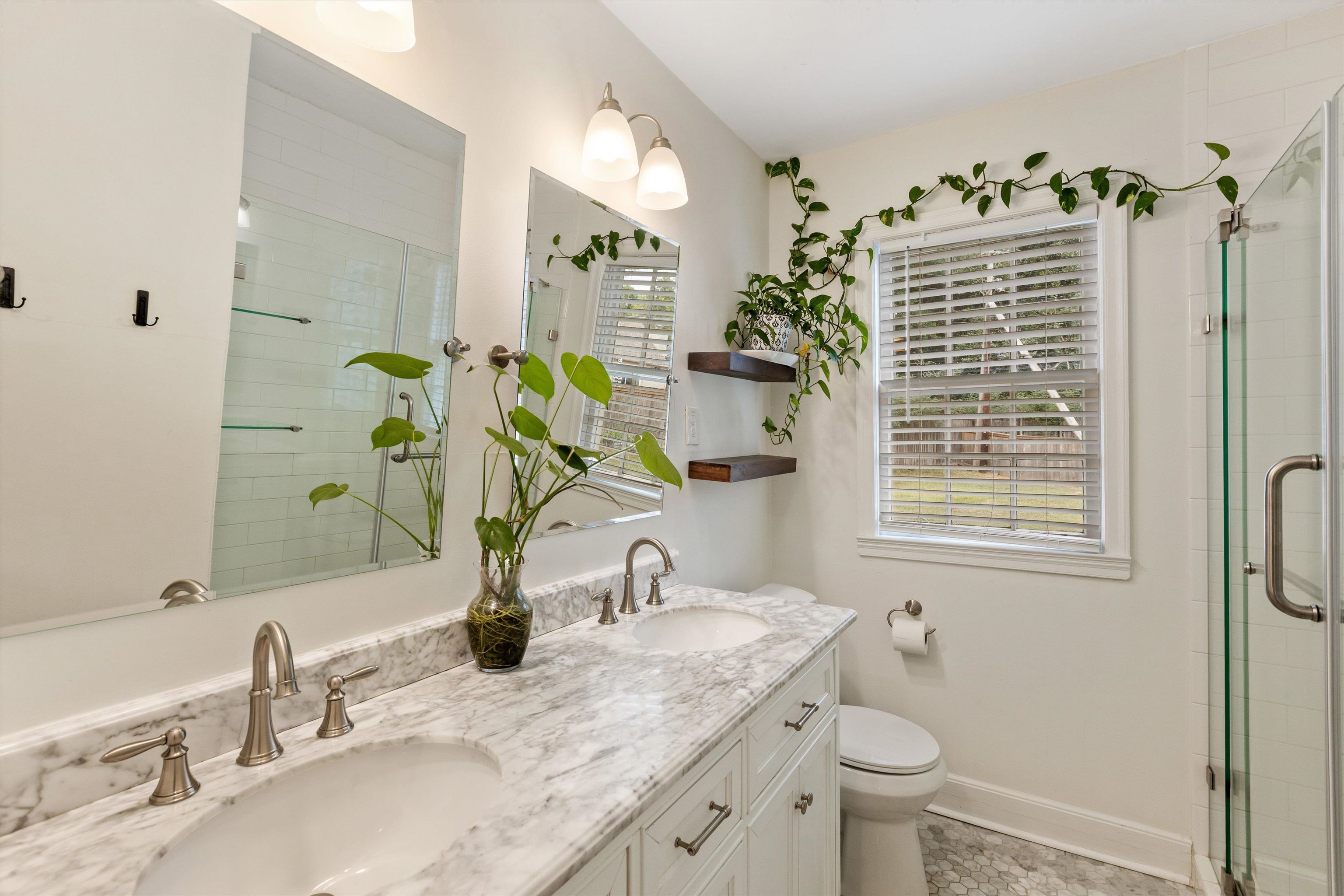 165 Picardy Street Memphis, TN 38111 - Photo 18 of 28 a bathroom with a granite countertop sink a toilet and a mirror